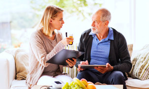 woman having conversation with senior man