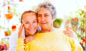 senior woman with female caregiver smiling