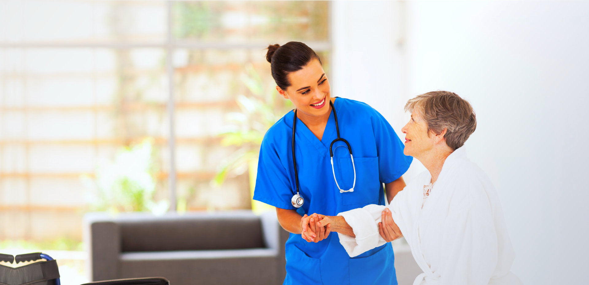 female medical staff assisting senior woman