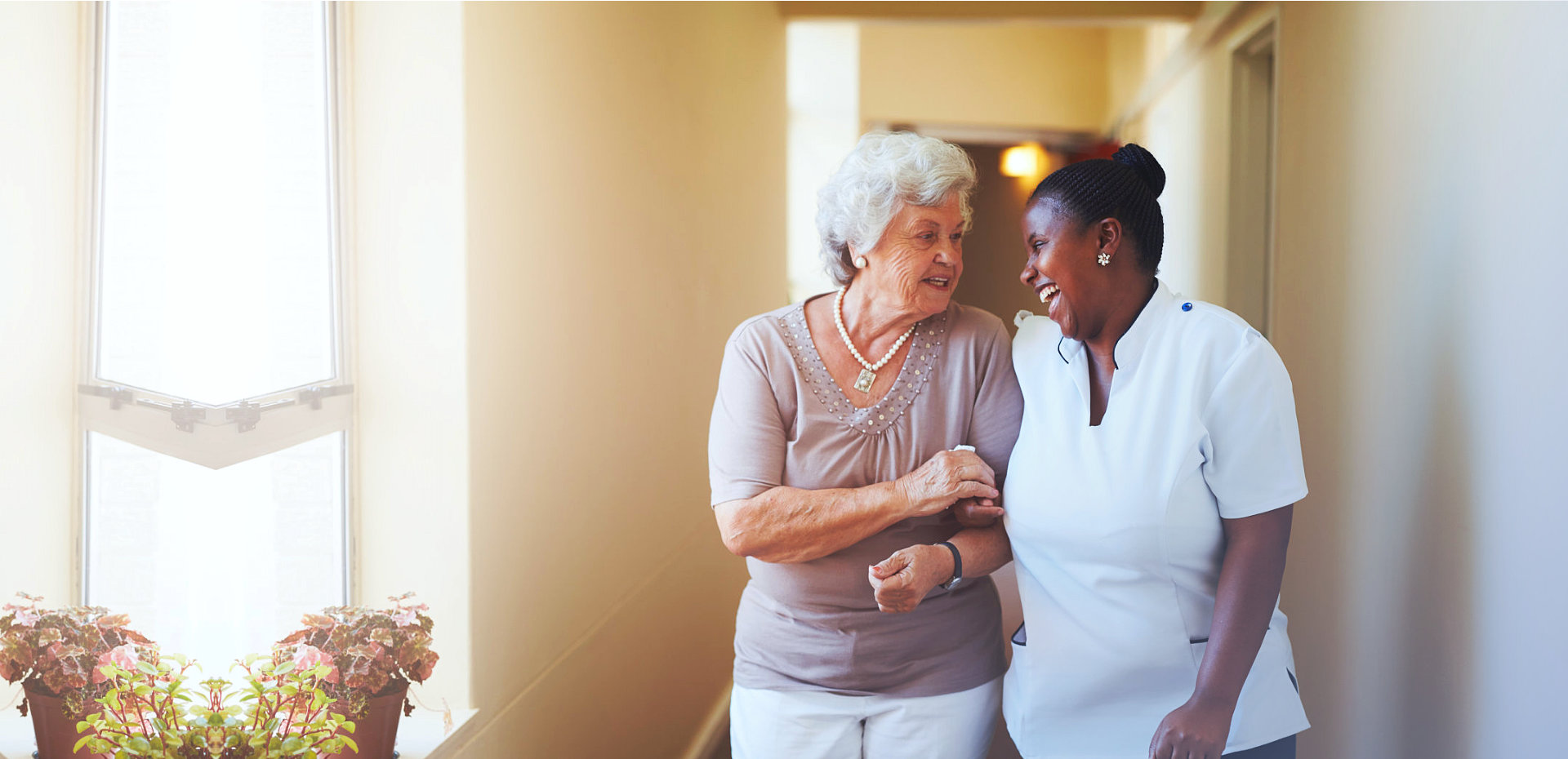 senior woman with caregiver smiling