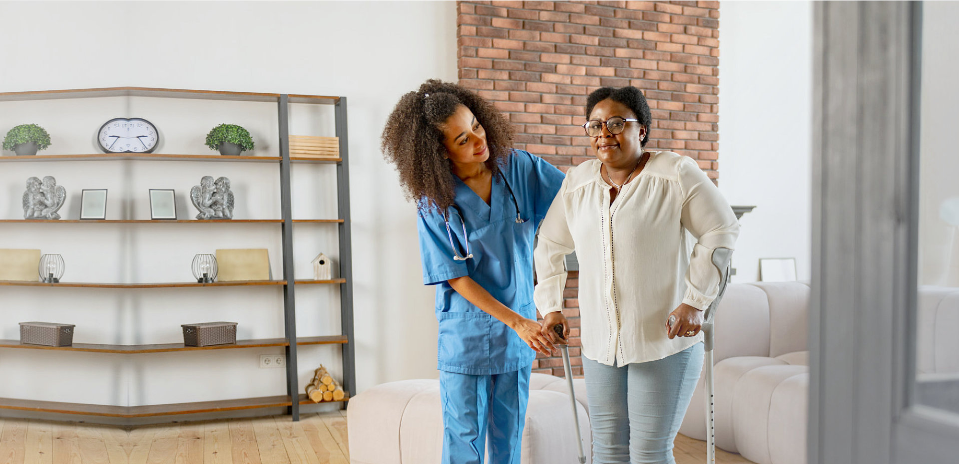 female medical staff assisting senior woman in standing