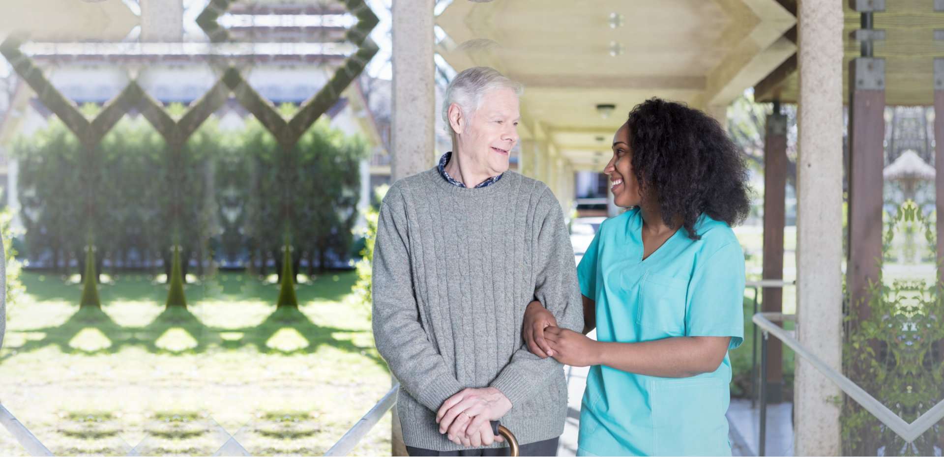 senior man with caregiver smiling