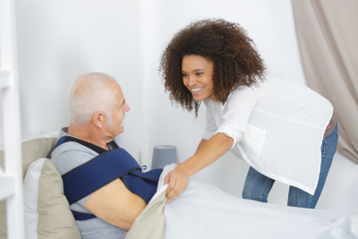 caregiver taking care of elderly man